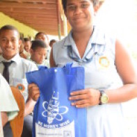 Dawasamu student with a prize after answering a quiz question correctly
