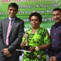 Microentrepreneur of the Year - 3rd Runner Up - Mrs Rosalia Sui receiving her Award from Mr Shaheen Ali the Permanent Secretary for Industry, Trade and Tourism and Mr Krishnan Narasimhan of the Pacific Financial Inclusion Programme