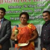 Microentrepreneur of the Year - 2nd Runner Up - Mrs Litea Marautaki receiving her Award from Mr Shaheen Ali the Permanent Secretary for Industry, Trade and Tourism and Mr Krishnan Narasimhan of the Pacific Financial Inclusion Programme
