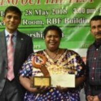 Microentrepreneur of the Year - Mrs Meri Reki receiving her Award from Mr Shaheen Ali the Permanent Secretary for Industry, Trade and Tourism and Mr Krishnan Narasimhan of the Pacific Financial Inclusion Programme